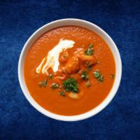 Butter Chicken Punjabi · Coal oven grilled tandoori chicken simmered in a smooth creamy tomato curry, garnished with ...