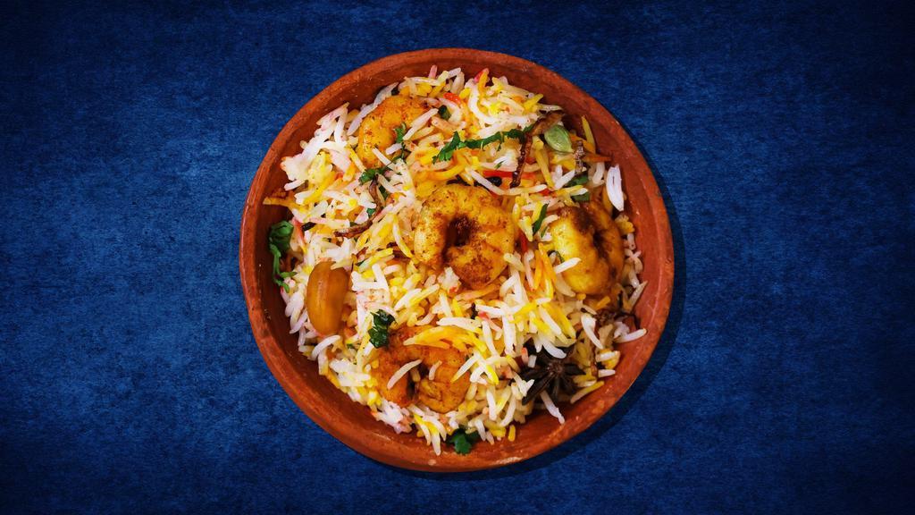 Shrimp Deluxe Biryani · Shrimps cooked in a special biryani masala curry, layered with imported long grain rice and steamed till cooked and smoked with coal.