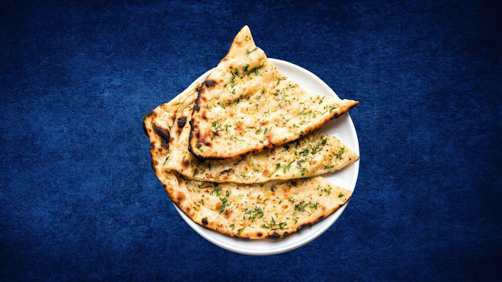 Garlic Naan · Fresh made leavened dough leaded with garlic and baked in a traditional coal oven