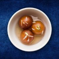 Classic Gulab Jamun · Village cheese dumplings deep fried and steeped in a cardamom infused sugar syrup.