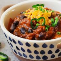 Texas Beef Chili · A delicious house Beef Chili prepared Texas style and without beans. Topped with sour cream,...