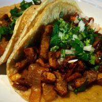 Al Pastor Taco (Pork, Pineapple) · Cilantro and onion.