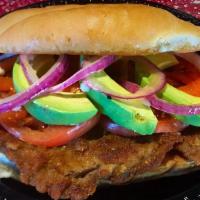 Torta Milanesa · Mexican style sandwich with breaded skirt steak, beans, mayo, tomato, red onion and avocado.