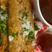 Birria Flautas (Consomme Included) · 3  birria beef flautas. Lettuce and sour cream and cheese, rice and beans