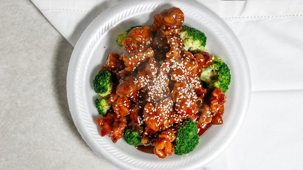 Sesame Chicken · Served with white rice. chunks of deep-fried chicken cooked with broccoli and sprinkle of sesame seeds.