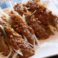006 Satay Tofu · Tofu shells filled with shredded cucumbers and sprouts. Topped with spicy peanut sauce
