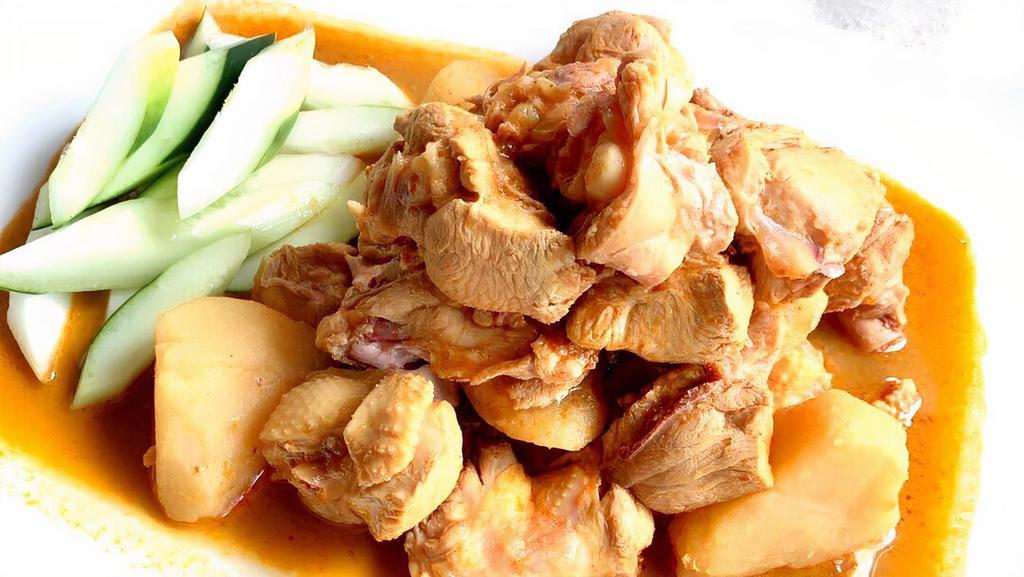 052 Kari Chicken · Spicy: Sharp, fiery taste. Chicken (bones in) and potatoes simmered in a mild coconut red curry.