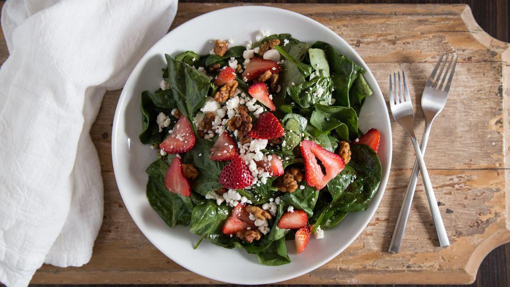 Strawberry Spinach Salad · Gluten-free. Fresh spinach, goat cheese, strawberries, and spiced walnuts tossed in balsamic vinaigrette.
