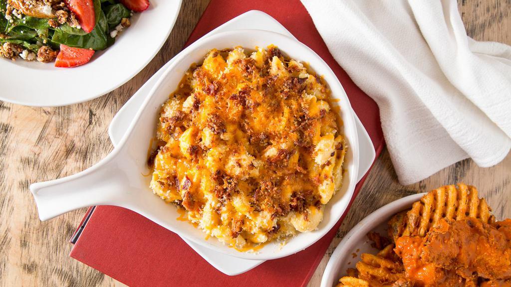 Mac 'N Cheese · A delicious blend of cheeses and tender shell pasta topped with toasted Parmesan and seasoned bread crumbs.