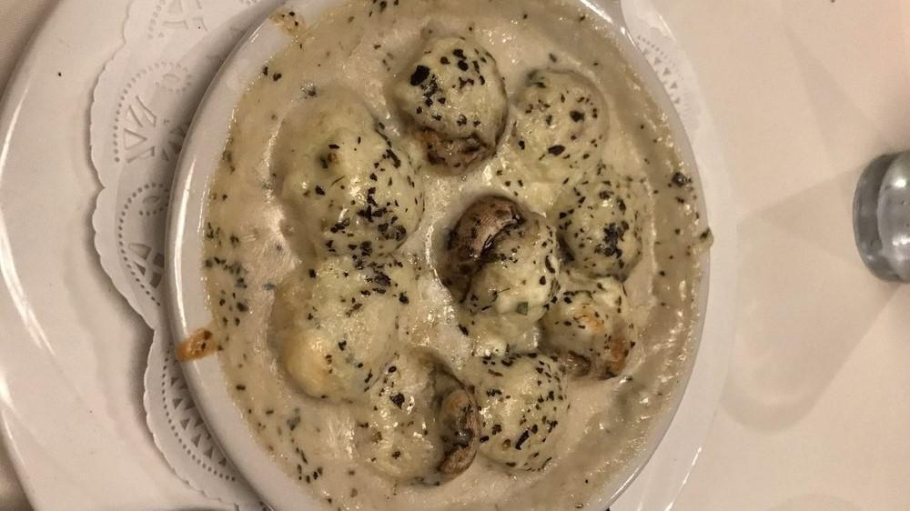 Stuffed Mushrooms · Stuffed with artichoke hearts &  baked in gorgonzola sauce