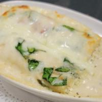 Manicotti · Filled with Italian cheeses and herbs, baked florentine-style, in an alfredo sauce with a sp...