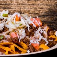 Super Nachos · Corn tortilla chips with beans, chicken or beef, beans, lettuce, tomatoes, sour cream, guaca...