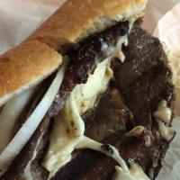 Ribeye Steak Sandwich · Thinly cut and freshly grilled ribeye steak topped with grilled onions, crisp lettuce, red t...