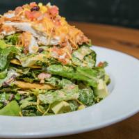 Southwest Tostada · Fried chicken, romaine, avocado, corn, black beans, cheddar, pico de gallo, lime, southwest ...