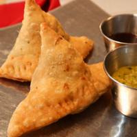 Vegetable Samosa (2) · Crisp pastries stuffed with spiced potatoes.