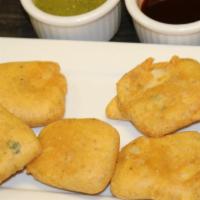 Paneer Pakora · Pieces of homemade cheese, dipped in chick-pea batter and deep fried.