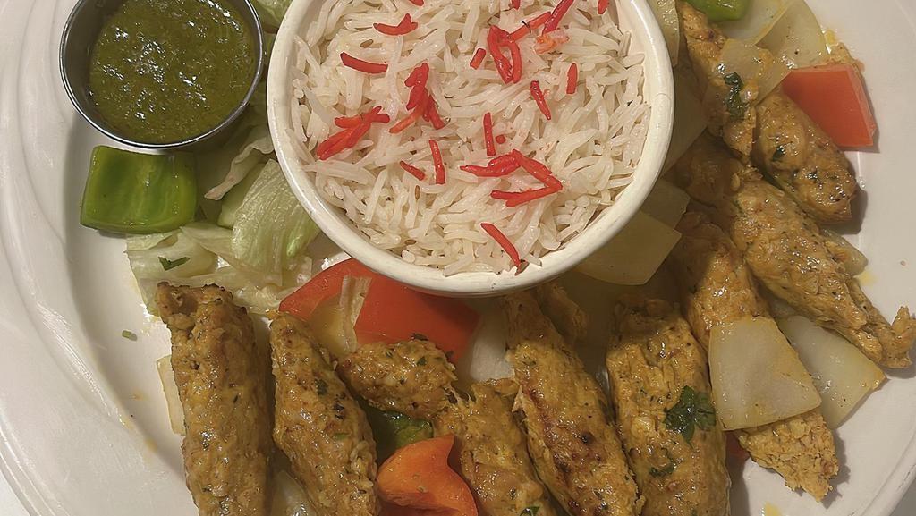 Chicken Kabab · Ground meat with ginger, garlic, onion, seasonings & herbs, roasted to perfection in our clay oven served with a salad of cucumber, tomato and onion.