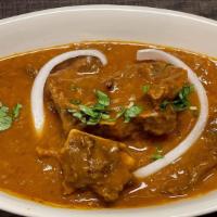 Goat Curry · Goat meat on the bone cooked with gravy sauce and spices.