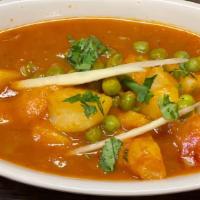 Aloo Mattar · Fresh green peas, cooked in a spiced sauce with potatoes.