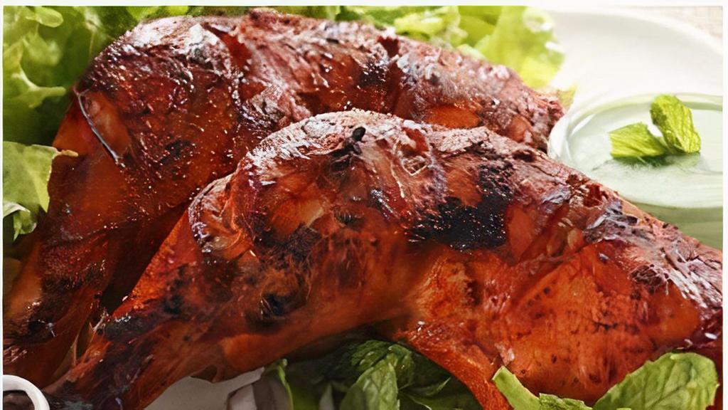 Tandoori Chicken (Half) · Marinated in tandoori sauce with herbs, ginger, garlic and homemade yoghurt, grilled in the tandoor clay oven.