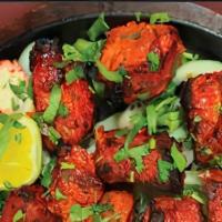 Chicken Tikka · Cubes of chicken marinated in light spices and yogurt and grilled in tandoori oven.