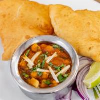 Chole Bhatura · Puffy deep fried bread served with chickpea curry.