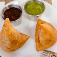 Vegetable Samosa · Deep fried crisp pastries stuffed with mildly spiced mashed potatoes and green peas.