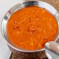 Butter Chicken · Chicken cubes roasted in the tandoor and cooked in a rich tomato cream sauce with cinnamon, ...