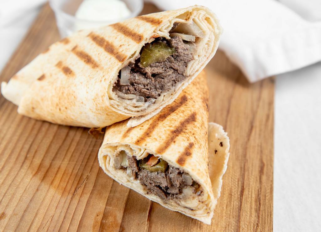 Meat Shawarma · Marinated beef with spices. served with soup or salad and a choice of rice or fries.