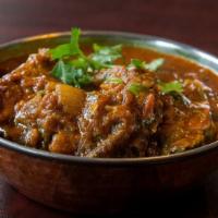 Fish Curry · Marinated swai fish, cooked with onion tomato and garlic ginger sauce. Served with basmati r...