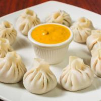 Chicken Momo · A traditional delicacy of Nepal. Chicken momos are a type of steamed dumplings with a season...