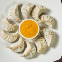 Vegetable Momo · A traditional delicacy of Nepal this vegan dish is a type of steamed dumplings consisting of...
