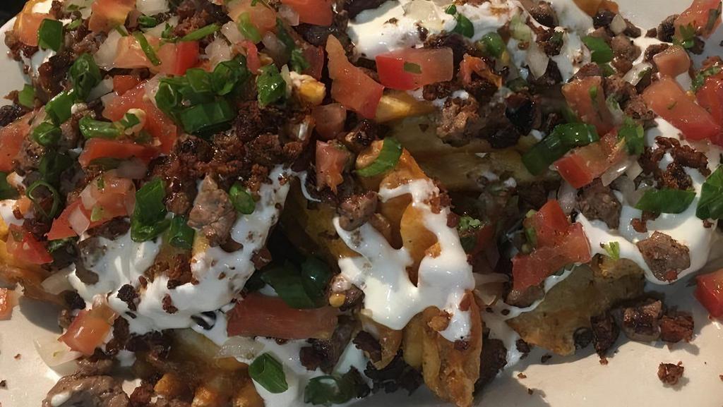 Asada Fries · Our Famous fries topped with queso blanco, Asada steak, and pico de gallo.
