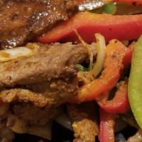 Steak Fajitas · Served with sauteed onions, bell peppers, lettuce, cheese, pico, rice and beans