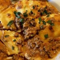 Ravioli Bolognese · cheese ravioli with our house beef and pork bolognese, parmesan