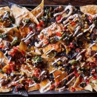 Small Supper Club Nachos (Prime Rib) · Fresh corn chips topped with triple cheese sauce, fontina and cheddar cheeses, poblano corn ...