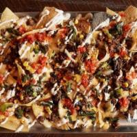 Large Supper Club Nachos (Spicy Chorizo) · Fresh corn chips topped with triple cheese sauce, fontina and cheddar cheeses, poblano corn ...