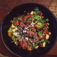 Golden Harvest Salad · Arugula and wild rice salad with roasted butternut, feta cheese, candied pecans, golden rais...