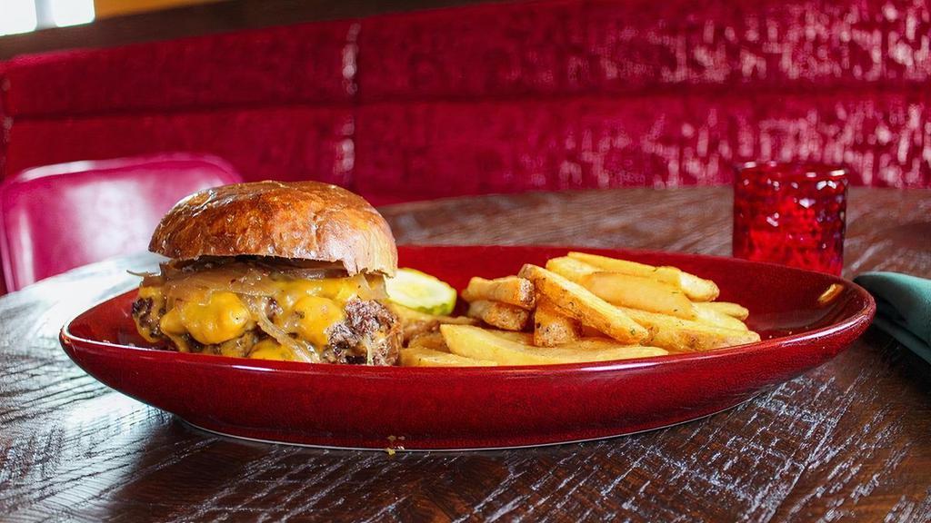 The Tavern Burger · Two ¼ lb. smashed patties with cheddar, caramelized onions, and pickles on a rye bun. Served with steak fries or a side salad.