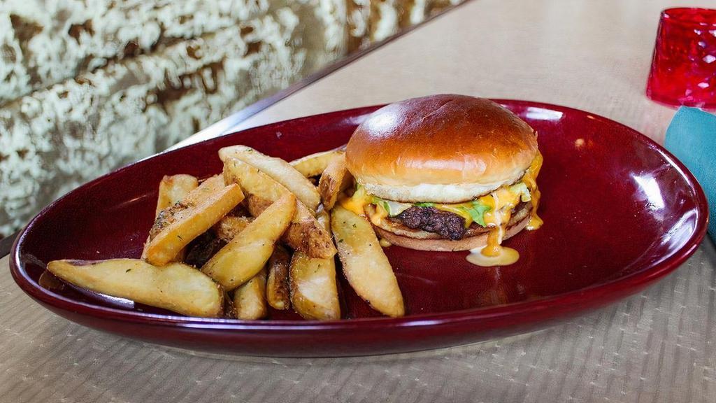 Daddy Mac Burger · 1/4 lb. smash patty, American cheese, thousand island dressing, and shredded iceberg on a toasted brioche bun. Served with steak fries or a side salad.