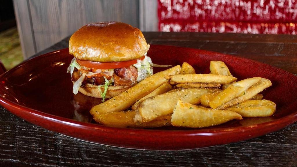 Black Buffalo Burger · 1/4 lb. smash patty, bacon, blackening seasoning, buffalo sauce, bleu cheese dressing, muenster, shredded iceberg, and tomato on a toasted brioche bun. Served with steak fries or a side salad.