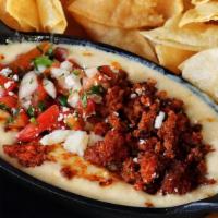 Fiesta Dip · Cheese dip with freshly grilled chorizo (Mexican sausage) and pico de gallo.