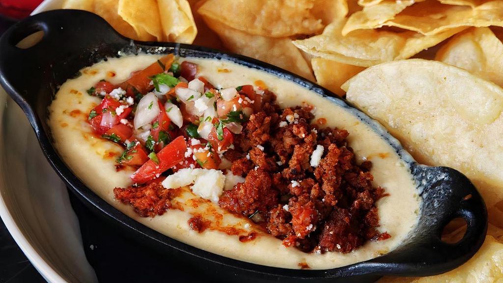 Fiesta Dip · Cheese dip with freshly grilled chorizo (Mexican sausage) and pico de gallo.