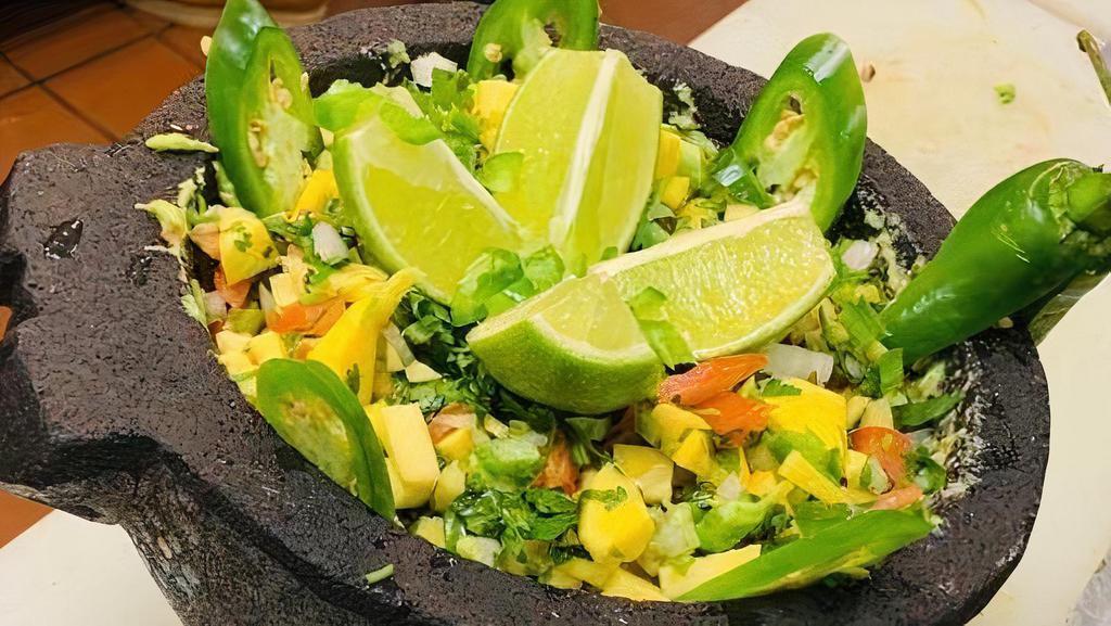Top Shelf Guacamole · Fresh avocado slices mixed with cilantro, red onion, tomato. Garlic, lime juice, salt and your choice of roasted corn, roasted pineapple, mango or bacon.