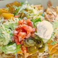 Nachos Supreme · Your choice of beef or chicken with lettuce, tomatoes, beans, sour cream and guacamole.