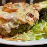 Piña Al Horno · Mix of grilled scallops, shrimp, crab, pineapple slices and onions, cooked in the oven, in a...