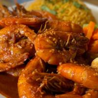 Camarones Cucaracha · Fried shrimp seasoning with a red Mexican peppers and garlic sauce, served with rice and ste...