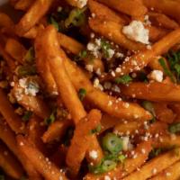 Buffalo Fries · Crispy fries doused in tasty buffalo sauce, topped with bleu cheese crumbles and green onions.