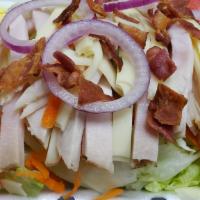 Cobb Salad · Crisp lettuce topped with turkey, bacon, onion, swiss cheese, hard boiled egg, tomato, olive...
