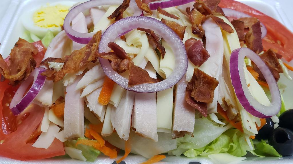 Cobb Salad · Crisp lettuce topped with turkey, bacon, onion, swiss cheese, hard boiled egg, tomato, olives and bleu cheese dressing on side.